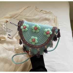 Detail of hand-woven mini bucket bag with crochet flowers and purple fringe tassels