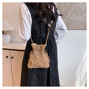 Détail du sac seau tissé à la main avec fermeture à cordon et perles en bois naturel
