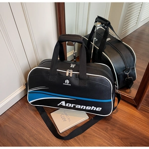 Detail view of the large capacity black leather sports bag with adjustable shoulder straps