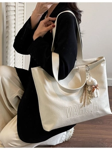 Chic cream tote bag with H.NAHS embossed logo and cute plush rabbit pendant for daily use