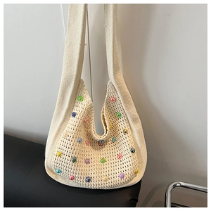 Detail of crochet tote bag with colorful beads and wide integrated shoulder strap