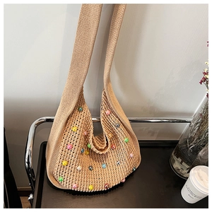 Detailed knit texture of beige crochet bag featuring vibrant multi-colored bead accents