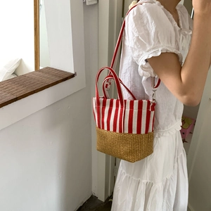Detail of red stripe canvas and straw weave tote bag with adjustable shoulder strap