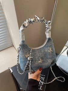 Blue denim dumpling bag with silver butterfly charms and chic metallic scrunchie handle