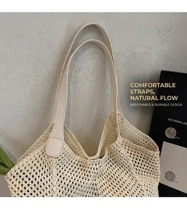 Detail of comfortable leather shoulder straps on a beige woven summer tote bag