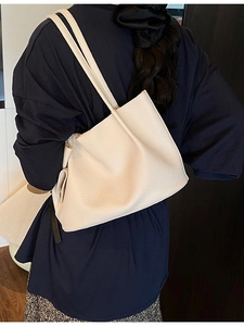 Elegant cream lychee textured tote bag styled with a modern outfit for a chic daily look