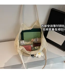 Detail of spacious interior in beige woven tote bag holding daily essentials and accessories