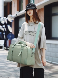 Sage green Boston travel bag with leather accents and wide adjustable shoulder strap