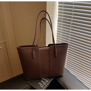 Détail du sac cabas en cuir grainé marron foncé avec coutures verticales élégantes