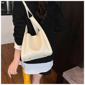 Detail showing the cream white crocodile pattern leather and bottom gold studs