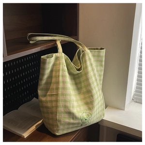 Détail du sac cabas en toile à carreaux verts avec motif de chien et grand volume