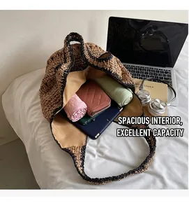 Close-up of spacious interior in straw tote bag with tablet and daily essentials