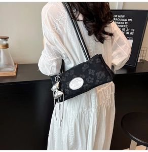 Dettaglio borsa a spalla in nylon nero con jacquard floreale e fiocco argento