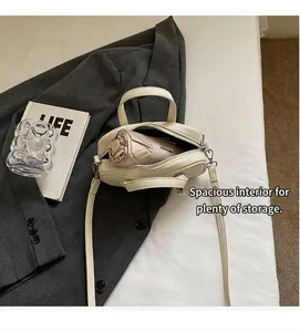 Detail view of cream Boston bag interior showing spacious storage for a folding umbrella