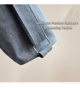 Close-up of polished silver rectangular metal hardware on premium blue denim tote bag