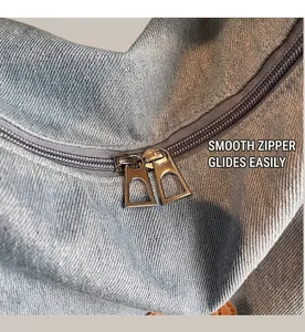 Detail of vintage denim tote bag featuring smooth double silver metal zippers
