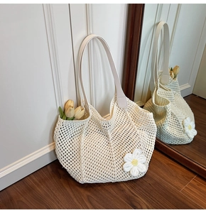Detail of hand-woven cream tote bag with 3D floral appliques and faux leather strap