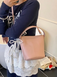Chic pink lychee texture bucket bag with pearl lace bow pendant and adjustable strap