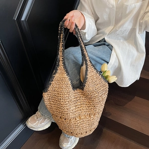 Straw tote bag with black contrast woven handles showing large capacity and tulip decor