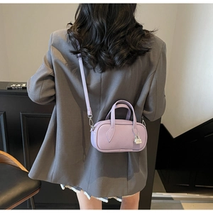 Detailed macro view of purple lychee pattern leather handbag with silver padlock charm