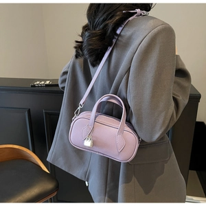 Chic lavender pebble leather satchel bag with silver padlock charm worn by model