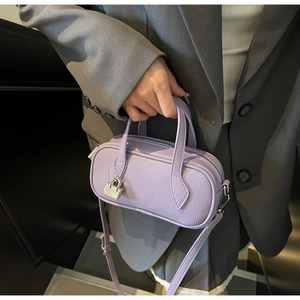 Detail of lavender pebble leather mini handbag with silver lock and top handles