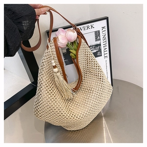 Detail der böhmischen beige gewebten Tragetasche mit braunem Ledergriff und Fransen