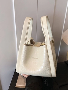 Chic beige crocodile embossed bucket handbag with elegant handle for modern women