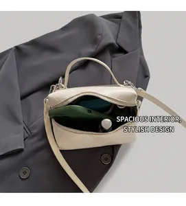 Detail view of the spacious interior of this creamy white pleated leather bucket handbag