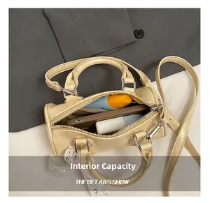 Internal capacity of beige pillow bag showing storage for phone and cosmetics