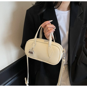 Detail of lychee pattern leather boston bag with silver lock and round handles