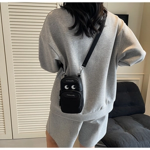 Detailed back view of a black mini crossbody phone bag with white eye motif and logo
