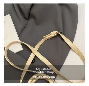 Detailed close-up of beige pillow bag adjustable strap with silver metal buckle
