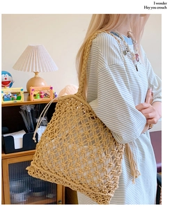 Close-up of beige large mesh hollow-out woven straw tote bag for summer beach holidays