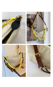 Detail of beige nylon crescent bag featuring multi-element patchwork shoulder straps