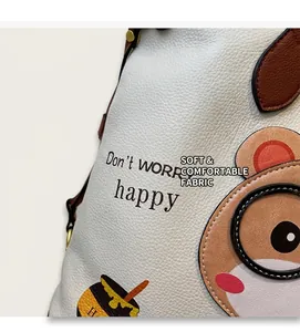 Detail of white lychee leather texture and cute cartoon bear print on a tote bag
