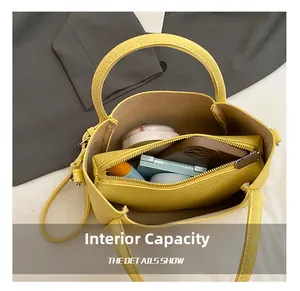 Macro view of yellow leather bucket bag interior showing large capacity for daily items