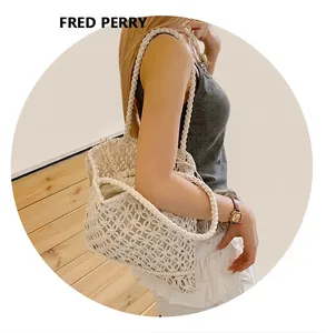 Close-up of white crochet tote bag showing intricate woven patterns and drawstring liner