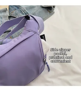 Detail view of purple nylon crossbody bag showing side zipper pocket with white earbud case