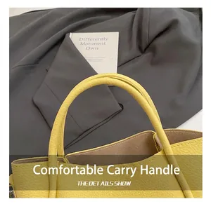 Close-up of yellow lychee pattern leather bucket bag with reinforced handles