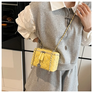 Quilted yellow box crossbody bag with silver rhinestones and flower charm shown on model
