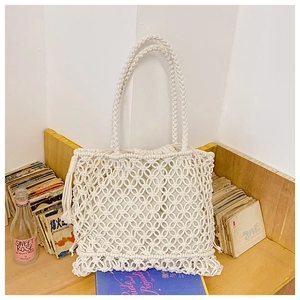 Detail of white cotton rope woven tote bag with diamond crochet patterns and drawstring liner
