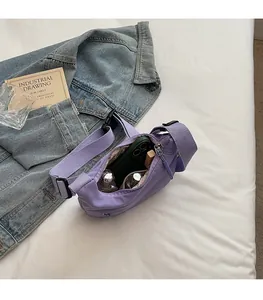Interior view of lavender nylon crossbody bag showing large capacity for essentials