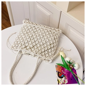 Detail of white handmade woven straw tote bag with drawstring lining and texture