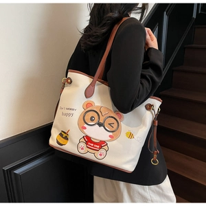 Detail of cute bear print on large cream tote bag with Don't Worry Happy text