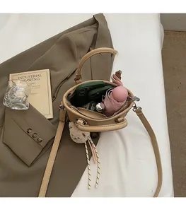 Top view showing spacious interior of the beige bucket bag with phone and umbrella