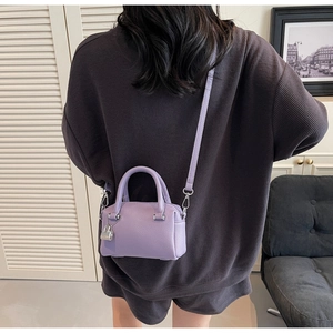 Close-up of purple lychee pattern leather mini Boston bag with silver lock detail