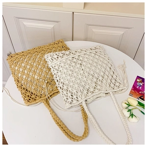 Detail of hand-woven cotton rope tote bags with mesh pattern and fringe tassels