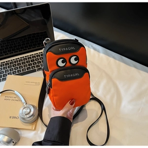 Detail view of orange nylon crossbody bag with cartoon eyes and TYPAGIRL print