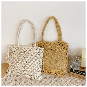 Detail of bohemian macramé tote bags showing intricate hollow-out weaving in two colors